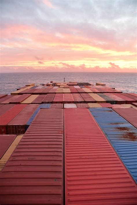 Container Ship Sailing Through Atlantic Ocean Toward Beautiful Sunrise