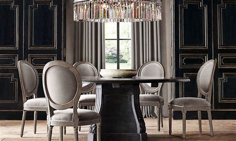 Beautiful dining room features a pair of the urban electric co chisholm lanterns illuminating a restoration hardware salvaged wood trestle rectangular dining table lined with white slipcovered skirted dining chairs. Restoration Hardware | Restoration hardware dining room ...