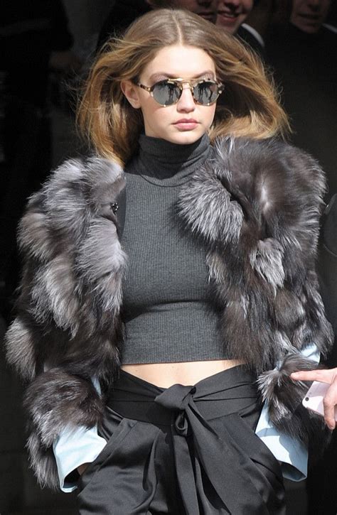 a woman with sunglasses on walking down the runway