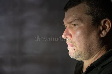 The Profile Of A Brooding Middle Aged Man Against The Gray Wall Short