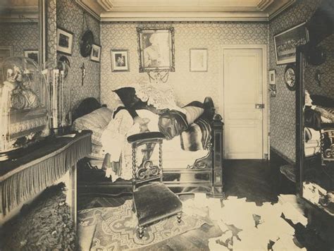 An Old Black And White Photo Of Two People Laying On A Bed In A Bedroom