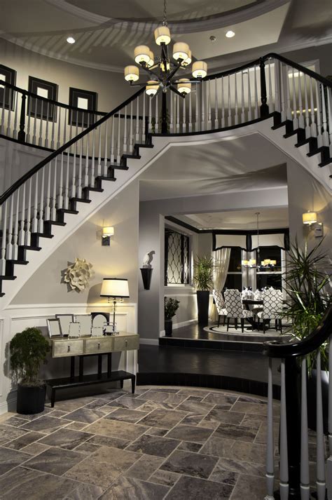 Double Arched Stairs Descending Down The Round Foyer Creating A Two