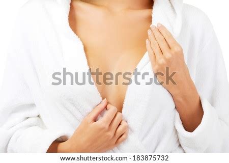 After making the die, they roll it, using the game sheet to track how many. Woman in bathrobe, close up on chest. Body part. - stock photo