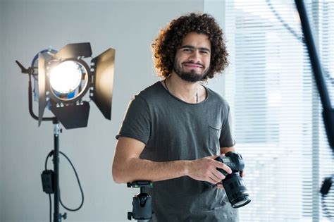 Premium Photo Happy Male Photographer Standing In Studio