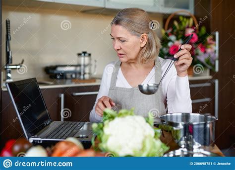Mature Woman In Kitchen Preparing Food Stock Image Image Of Dinner