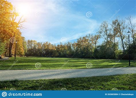 Picturesque View Of Park With Beautiful Trees And Pathway On Sunny Day