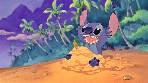 Stitch Is Sitting On Sand 4k 5k Hd Stitch Wallpapers Hd Wallpapers