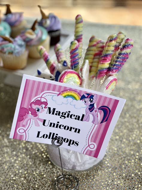 Cupcakes And Unicorn Lollipops Are On The Table