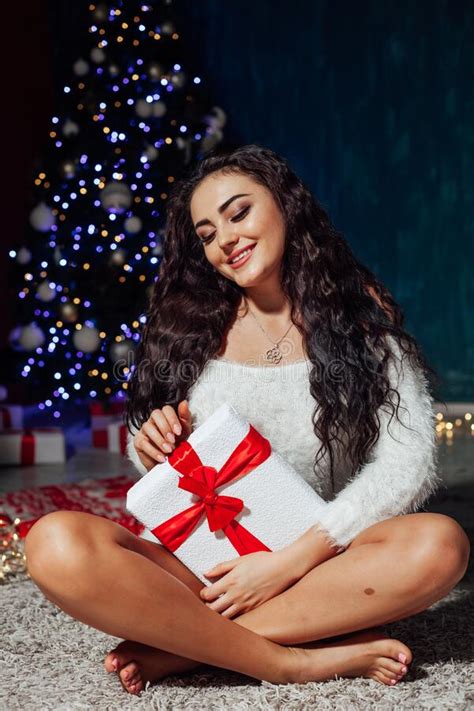 Beautiful Brunette Woman At Christmas Tree With Lights Garland Opens