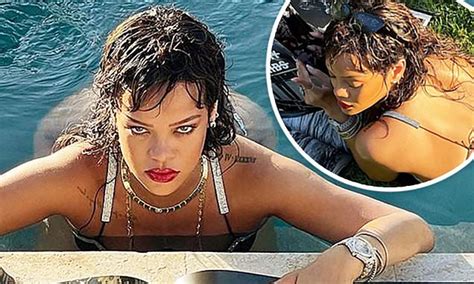 Rihanna Teases Her Backside As She Soaks In The Pool Beside A Giant Copy Of Her Photography Book