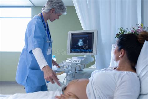 Female Doctor Doing Ultrasound Scan For Pregnant Woman Stock Photo