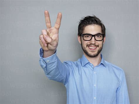 Businessman Doing Peace Sign Smiling Stock Photo