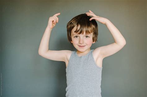 Little Boy In Vest Flexes His Muscles By Stocksy Contributor Rebecca