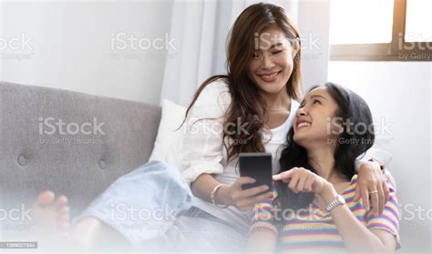 Young Beautiful Asian Women Lesbian Couple Lover Using Smartphone Video
