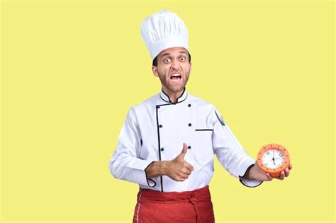Premium Photo Handsome Chef Cook White Outfit Holding Clock Indian Pakistani Model