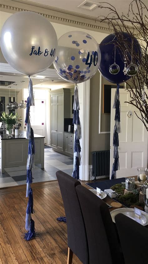 Blue And White Balloons Hanging From The Ceiling In A Room With Wood