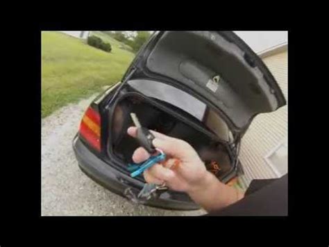 When the door is open there should be a button to open the trunk. 2003 BMW 3 series e46 locked keys in trunk - YouTube