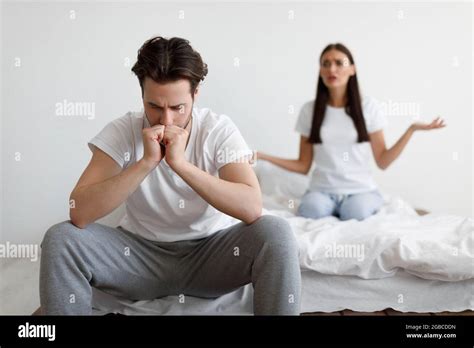 Discontented Wife Blaming Unhappy Husband Having Quarrel In Bedroom