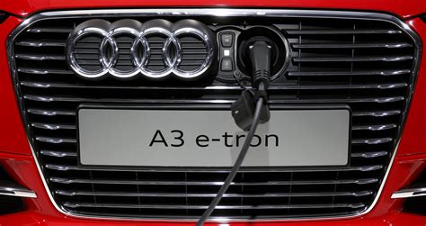 An Audi A3 E Tron Is Pictured Plugged To A Charging Station During A