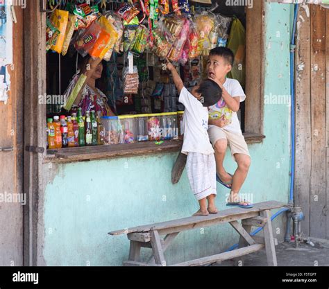 Two Boys Shopping At A Candy Shop In A Shanty Town At General Santos