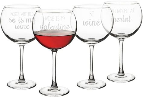 Four Wine Glasses With Red Wine In Them