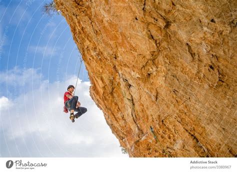 Courageous Female Climber Hanging On Cliff A Royalty Free Stock Photo