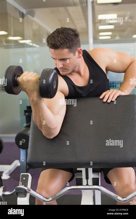 Focused Bodybuilder Lifting Heavy Black Dumbbell Stock Photo Alamy