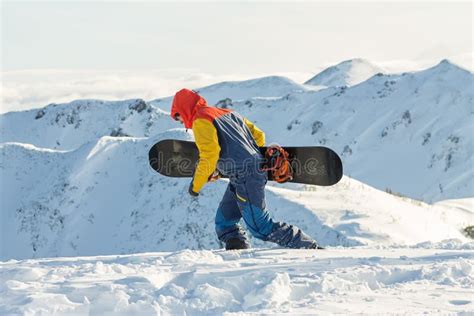 Snowboarder Freerider Is Going In The Snowy Mountains In Winter Under
