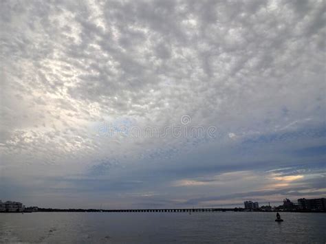 Blue And Grey Stormy Skies Above Ocean City Coastline Stock Image