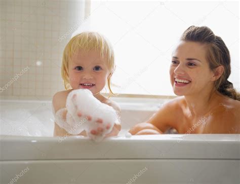 Baby Playing With Foam While Taking Bath With Mother Stock Photo By