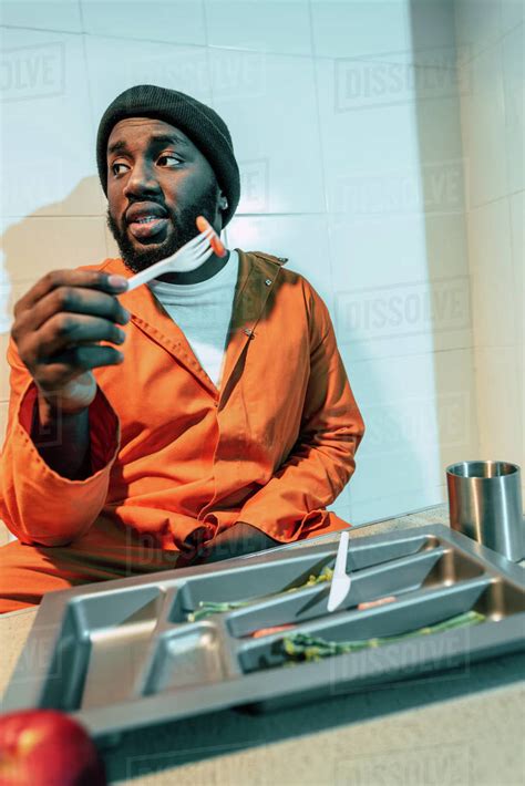 African American Criminal Eating In Prison Cell Stock Photo Dissolve
