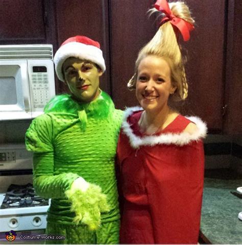 Two People Dressed Up In Costumes Standing Next To Each Other