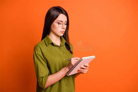 Photo Portrait Of Focused Serious Brunette Girl Taking Notes In Diary