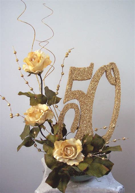 A Th Birthday Cake Decorated With Flowers And Gold Glitter Number