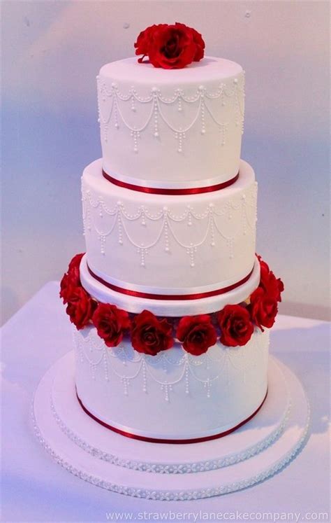 Three Tiered Wedding Cake With Red Roses On Top