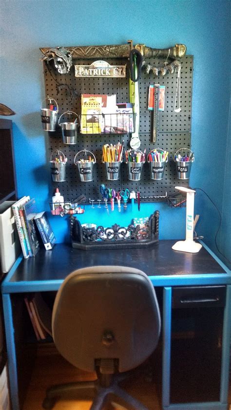 Pegboard organizer, plywood peg board shelf. A pegboard wall organizer with buckets for different ...