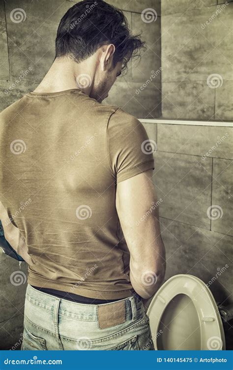 Rear View Of A Young Man Peeing At The Toilet Stock Image Image Of Standing Casual 140145475