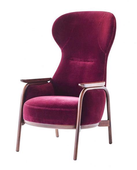 An Upholstered Purple Chair With Wooden Legs And Arms Viewed From The