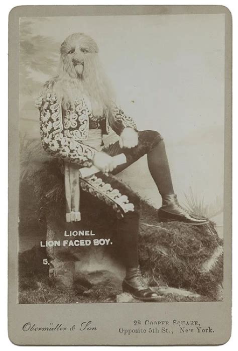 An Old Black And White Photo Of A Man With Long Hair Sitting On A Sign