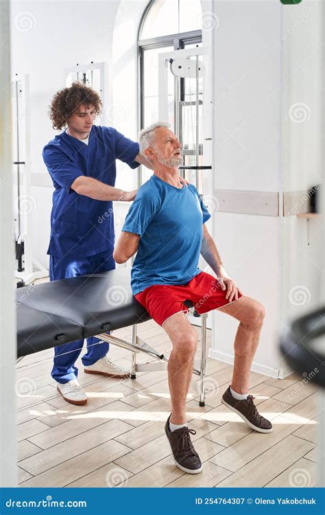 Old Man In Medical Rehabilitation And Physical Therapy Centre Stock