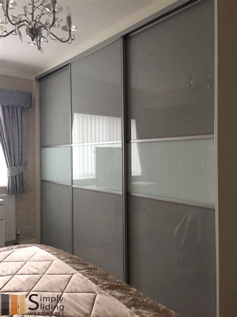 One Of Our Multi Panel Grey Glass Sliding Door Wardrobes Sliding