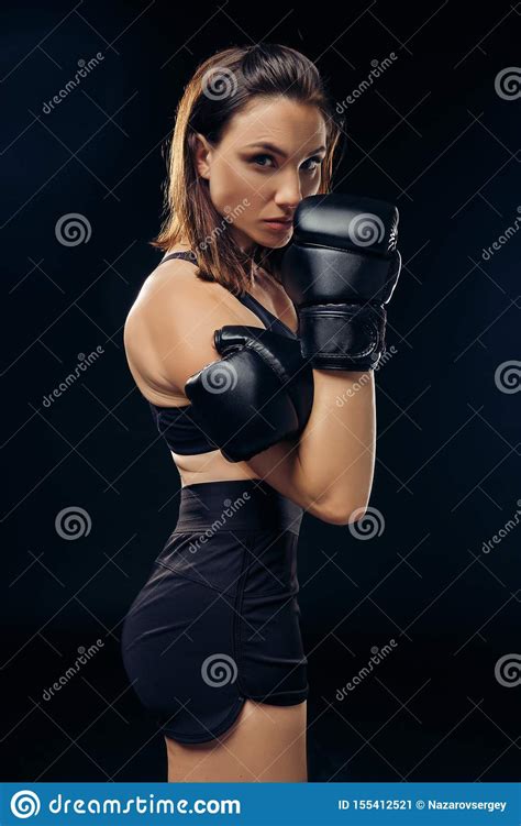 Athletic Woman In Boxing Gloves Is Practicing Karate In