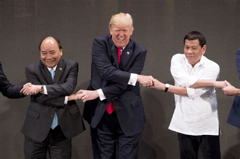 Befuddled By Group Handshake Trump Strains Grimaces And Finally