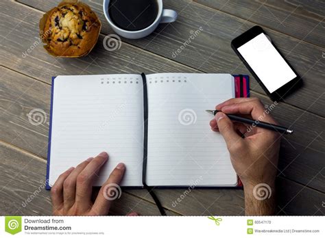 Person Writing On A Diary At The Desk Stock Photo Image