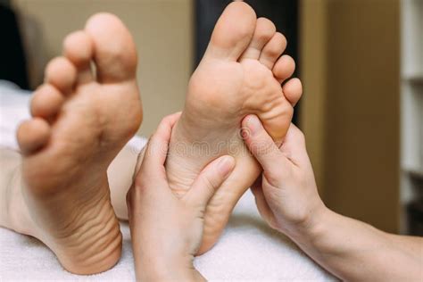 the masseur gives a massage to the female feet at the spa stock image image of professional