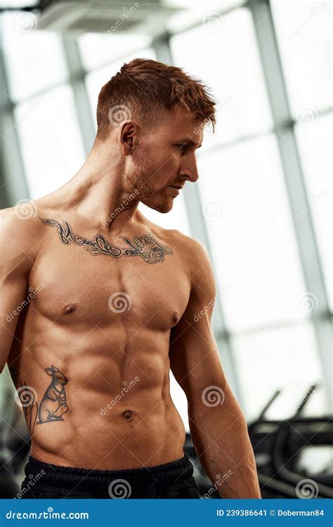 Portrait Of Muscular Topless Man Sweating After Workout Exercise At