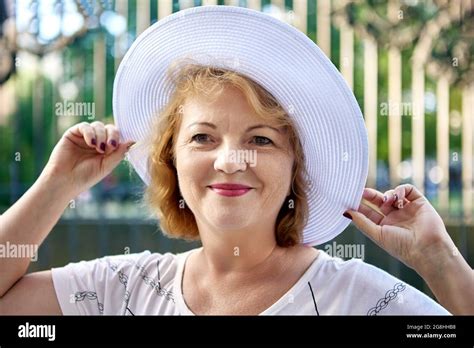 Senior Beautiful Woman 54 Years Old In White Hat Smiles While Walk
