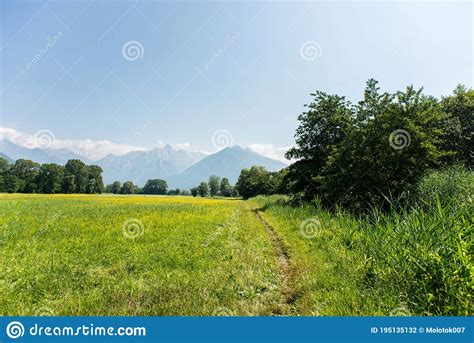 Panoramic View Of Idyllic Mountain Scenery In The Alps With Fresh Green