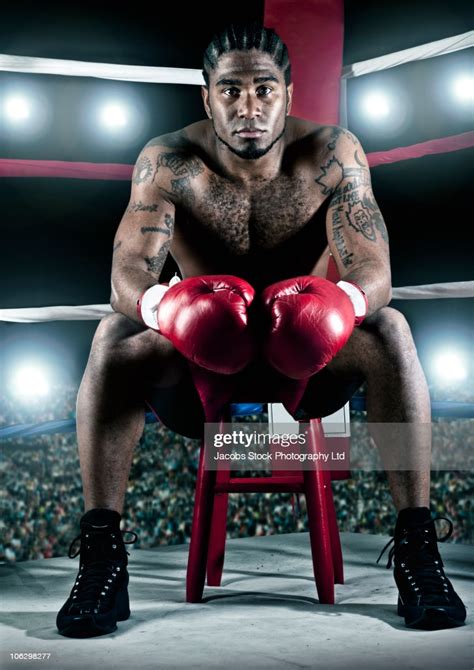 African American Boxer Sitting In Boxing Ring High Res