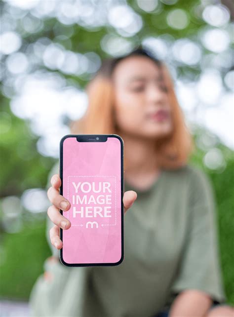 Iphone Mockup Featuring A Woman Posing While Showing Off Her Phones